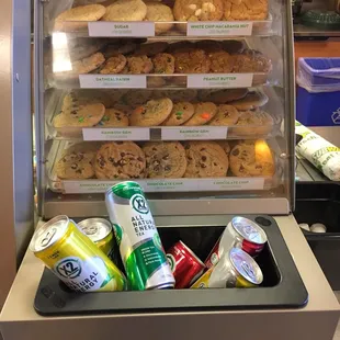 a display case full of cookies and sodas