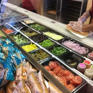 a variety of salads in a deli case