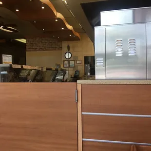 Employees in back talking loudly instead of working and blaring their music