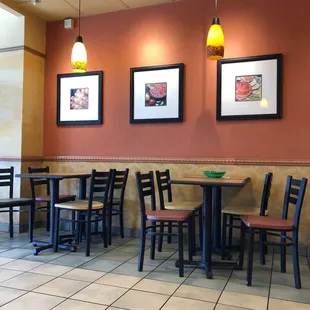 a dining area with tables and chairs