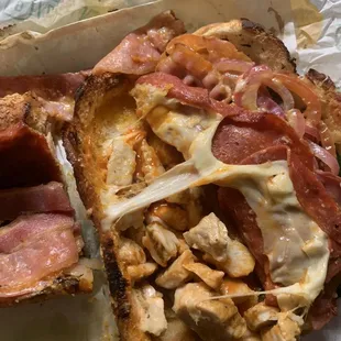 a closeup of a sandwich with meat and cheese