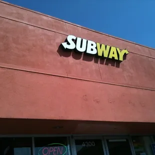 a subway sign on the side of a building