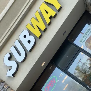 a subway sign on the side of a building