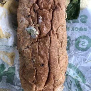 a hand holding a piece of bread