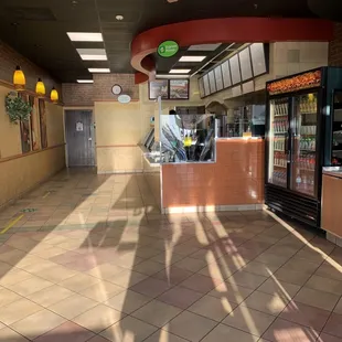 the inside of a restaurant with a ceiling fan