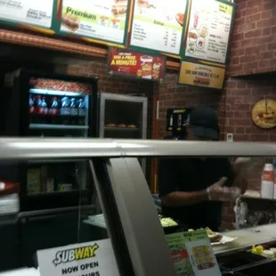 a view of a restaurant counter and menus