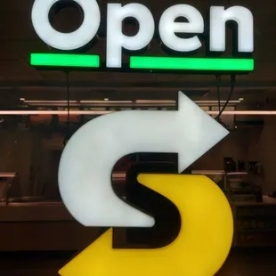 a neon sign with an arrow pointing to the right