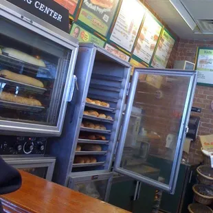 a man standing in front of a bakery counter
