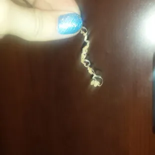 a person's hand holding a bottle opener