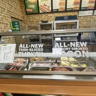 a display case with a variety of food items
