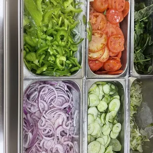 a variety of vegetables in trays