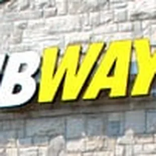 a subway sign on the side of a building