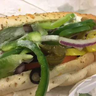 a sub sandwich with peppers, onions, and peppers