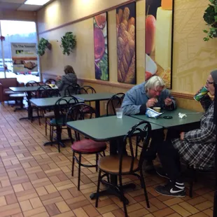 people sitting at tables in a restaurant