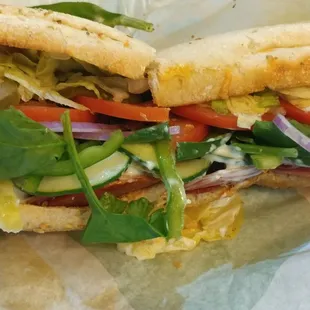 a sub sandwich with lettuce and tomatoes