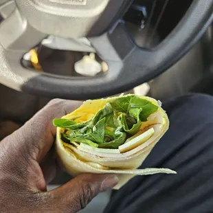 a man holding a sandwich in his hand