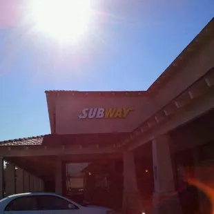 a car parked in front of a subway restaurant