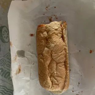 a hot dog in a bun on a wrapper