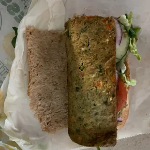 a sandwich with lettuce, tomato, and cucumber