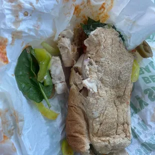 a chicken sandwich with lettuce and pickles