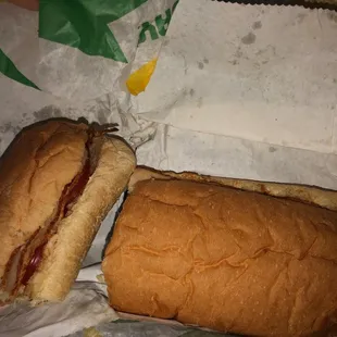 a half eaten sandwich and a half eaten sandwich