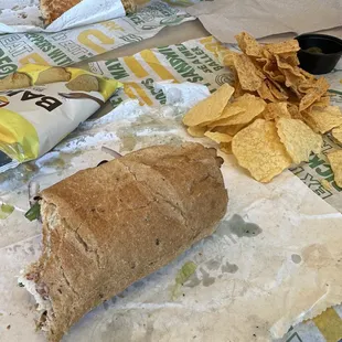 a sandwich and chips on a table