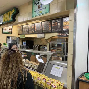 a woman ordering food at the counter