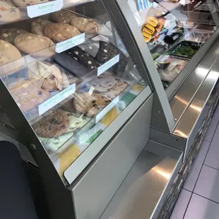 a display case with a variety of baked goods