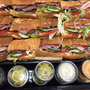 a tray of sandwiches with condiments