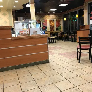 the inside of a restaurant with tables and chairs
