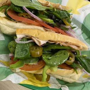 a sub sandwich on a paper plate