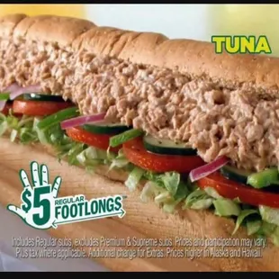 a tuna sandwich with lettuce and tomatoes