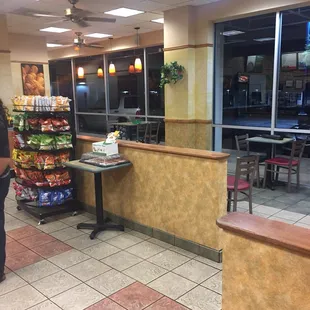 a woman standing at a counter in a restaurant