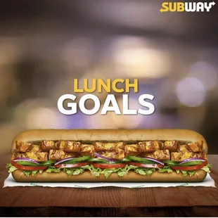 a sub sandwich on a wooden table