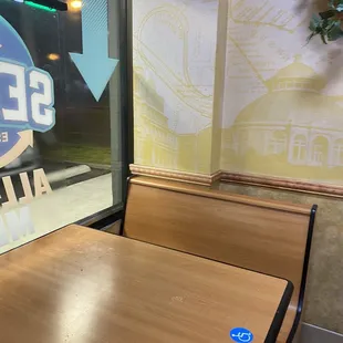 a table and benches in front of a window