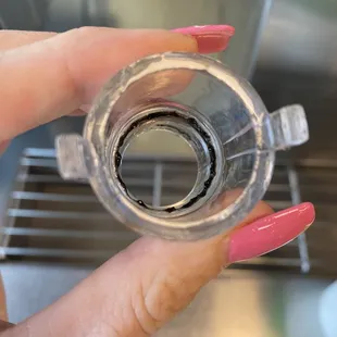 a hand holding a cup of water