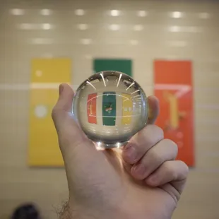 a hand holding a glass with a subway logo on it