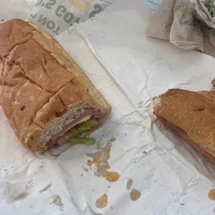 a half eaten sandwich and a half eaten sandwich