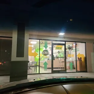 the front of a subway restaurant at night