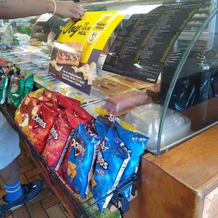 a man reaching for a bag of chips