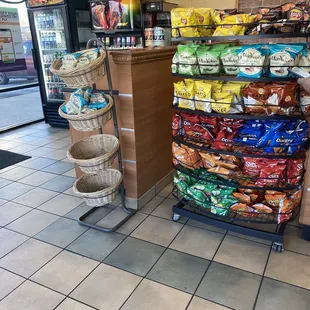 a grocery store with a cart full of chips