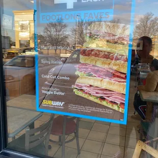 a sign in the window of a subway restaurant