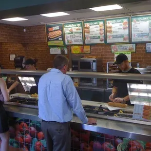 people ordering food at a subway restaurant