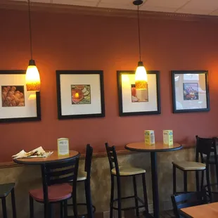 Cleverly matted art over uncleaned tables.