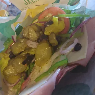 a closeup of a sandwich with pickles