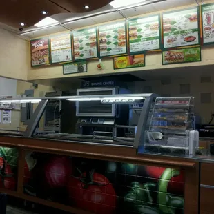 a view of a food court with menus on the wall