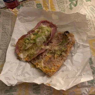 a sandwich with meat, lettuce, and cheese
