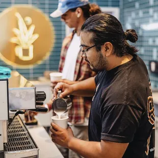 a man making a cup of coffee