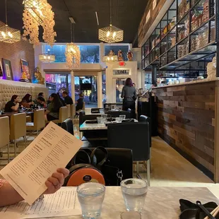 a man reading a menu at a restaurant