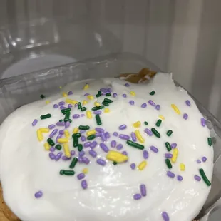 a cupcake with white frosting and sprinkles
